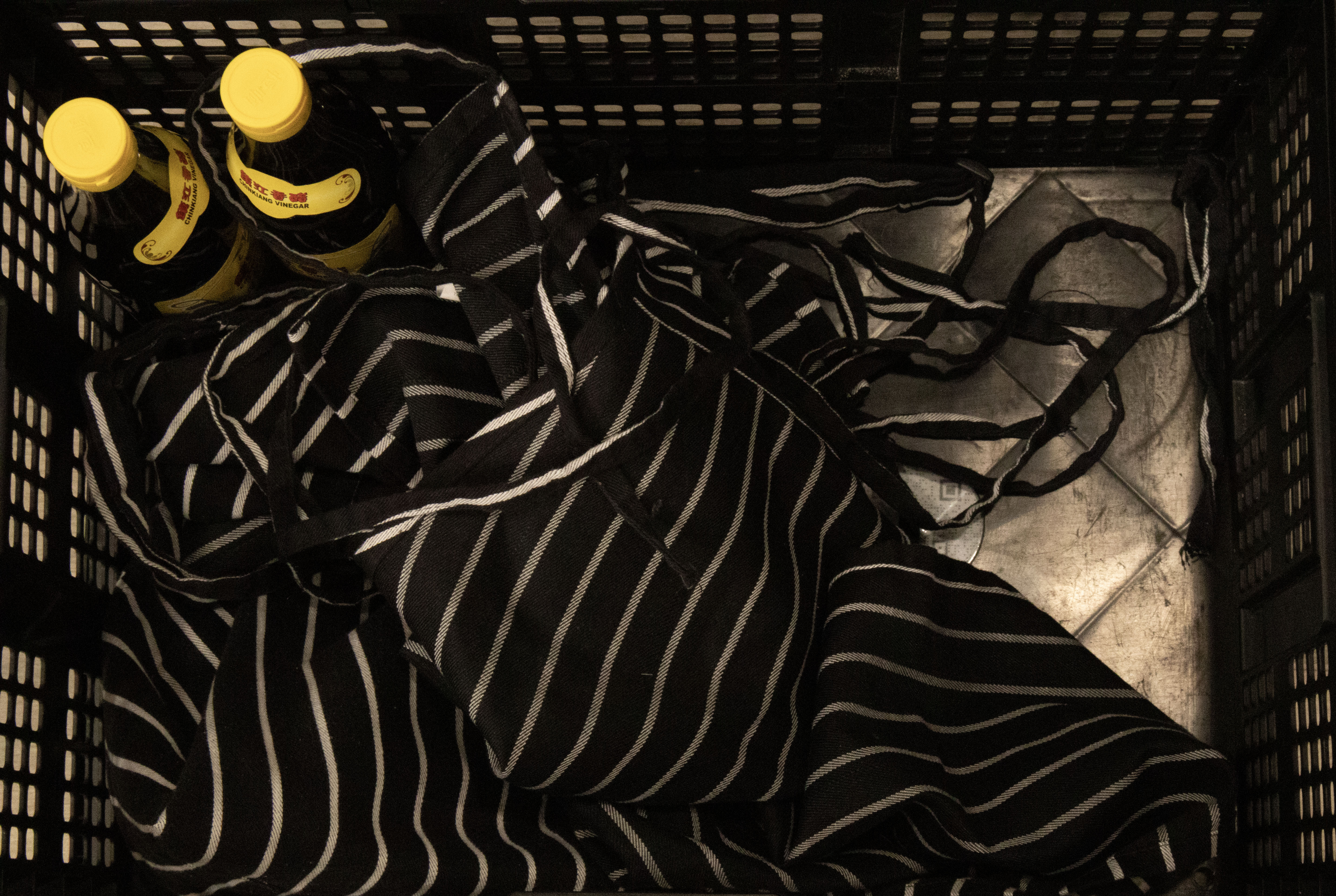 apron and sauce in a black crate